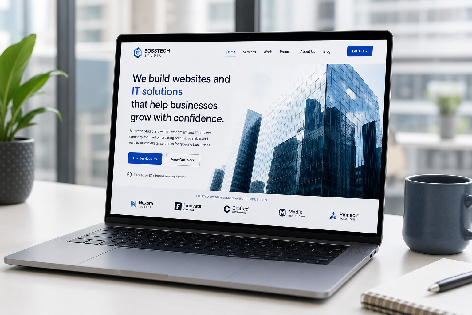 Laptop displaying a professional business website on a modern office desk.